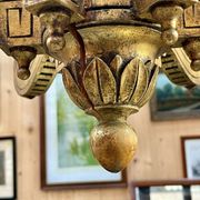 Golden wooden chandelier with crystal pendants from the 19th century.