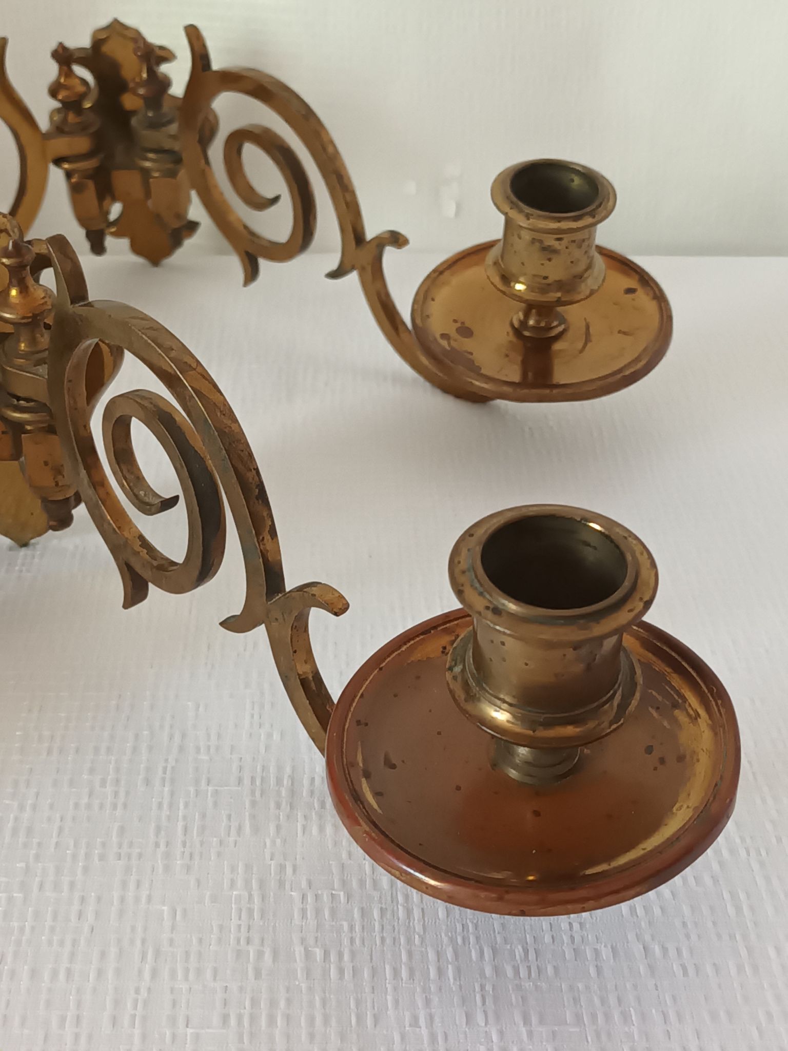 Pair of antique wall-mounted brass candle holders