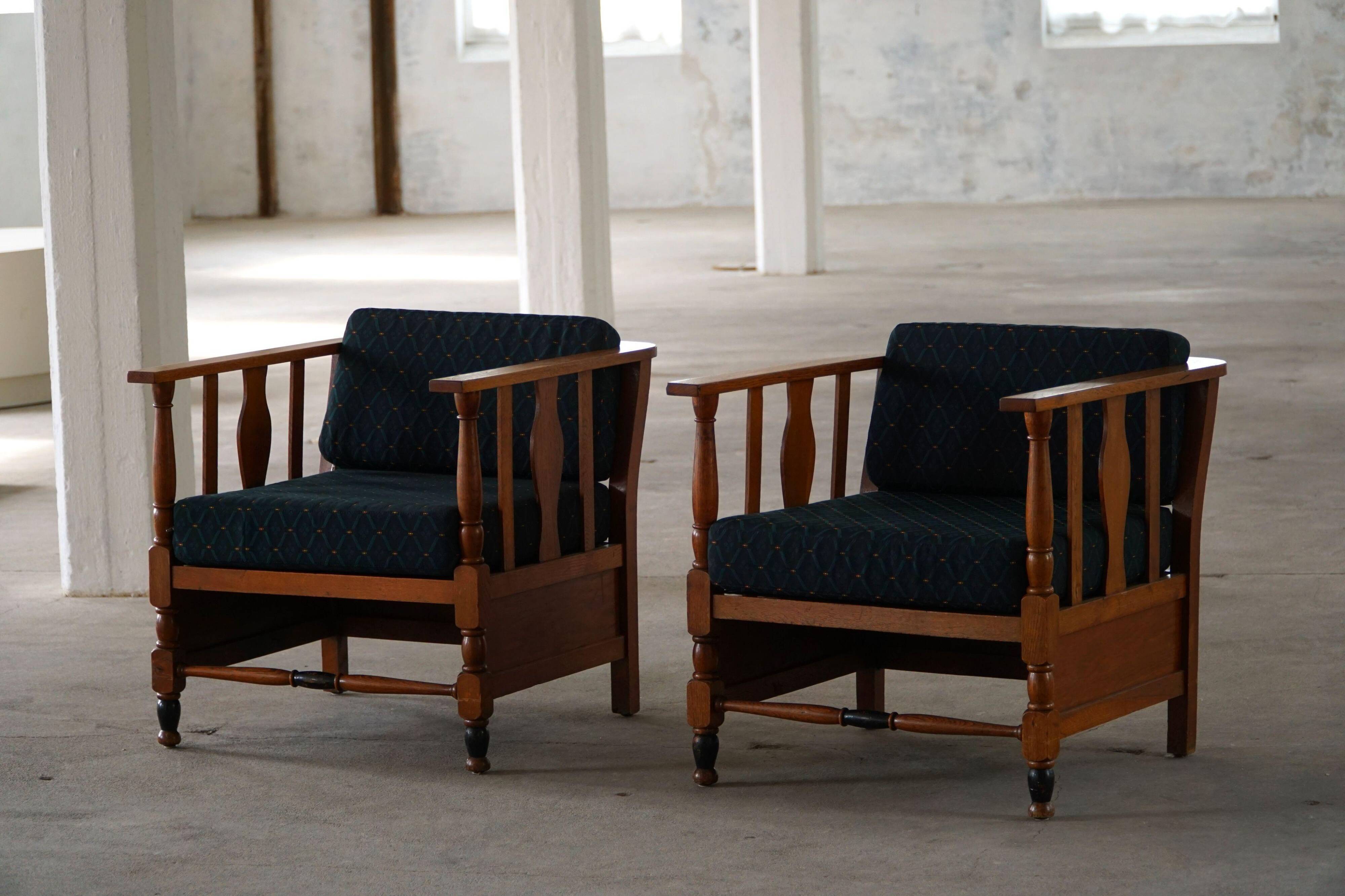 Art Nouveau, pair of oak lounge chairs, reupholstered in style fabric, 1920s.