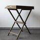Folding and removable service tray in taupe-painted wood.