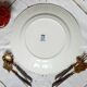 Old mismatched iron earthenware dessert plates accompanied by a dish