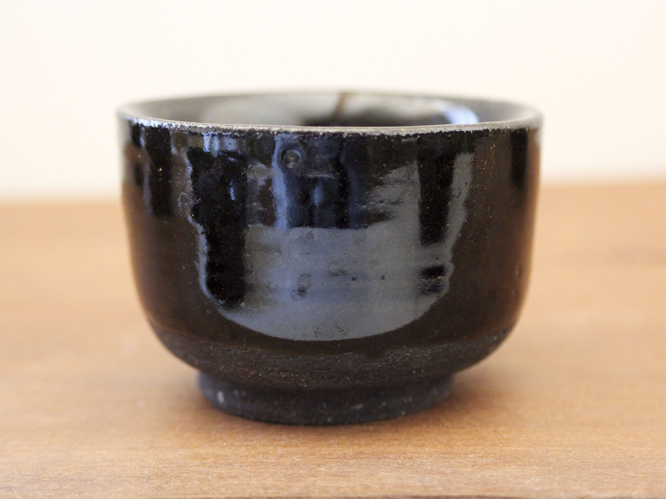 Set of 8 black ceramic cups signed