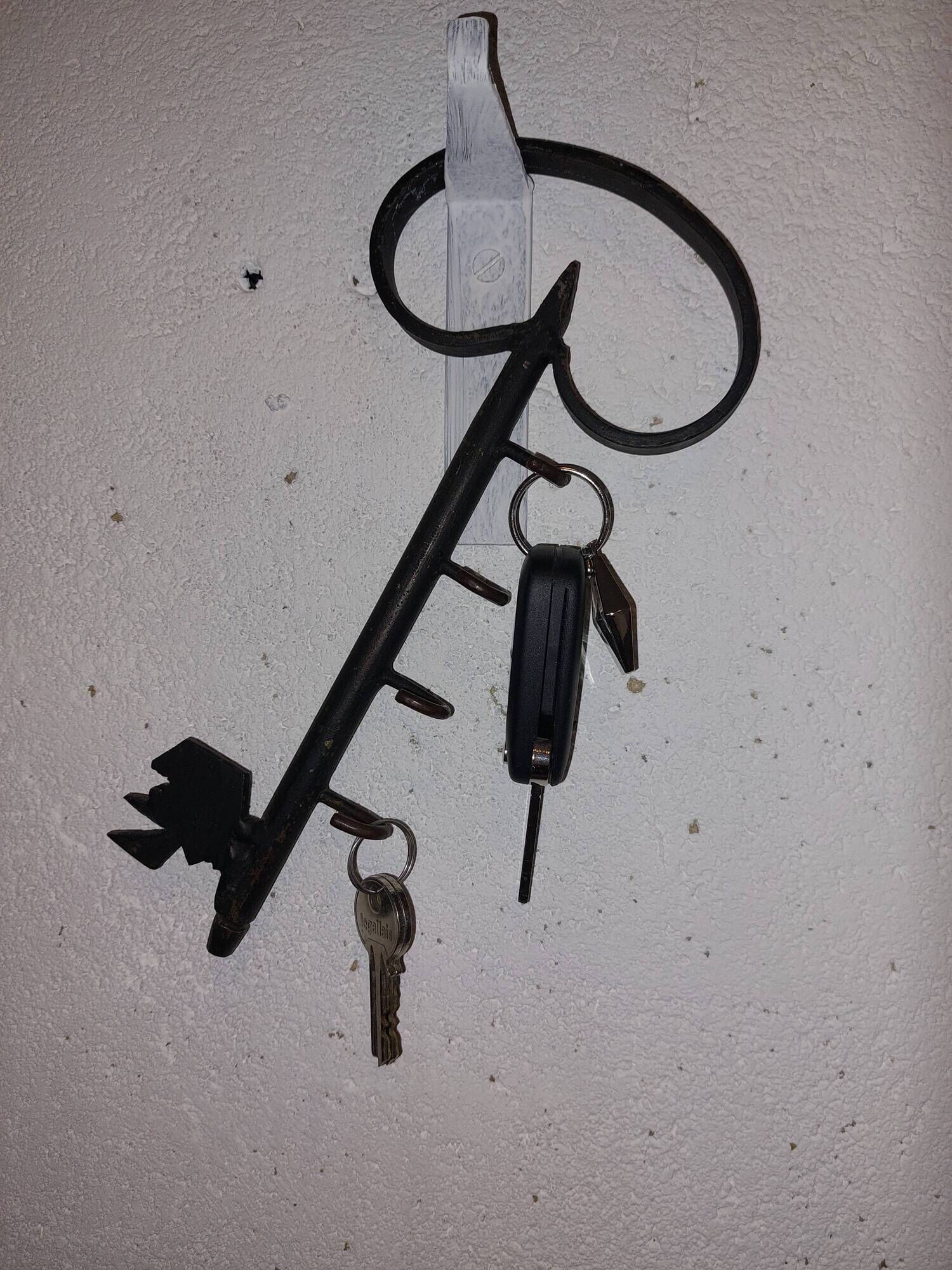 Old wall key holder in the shape of a vintage metal key 4 hooks