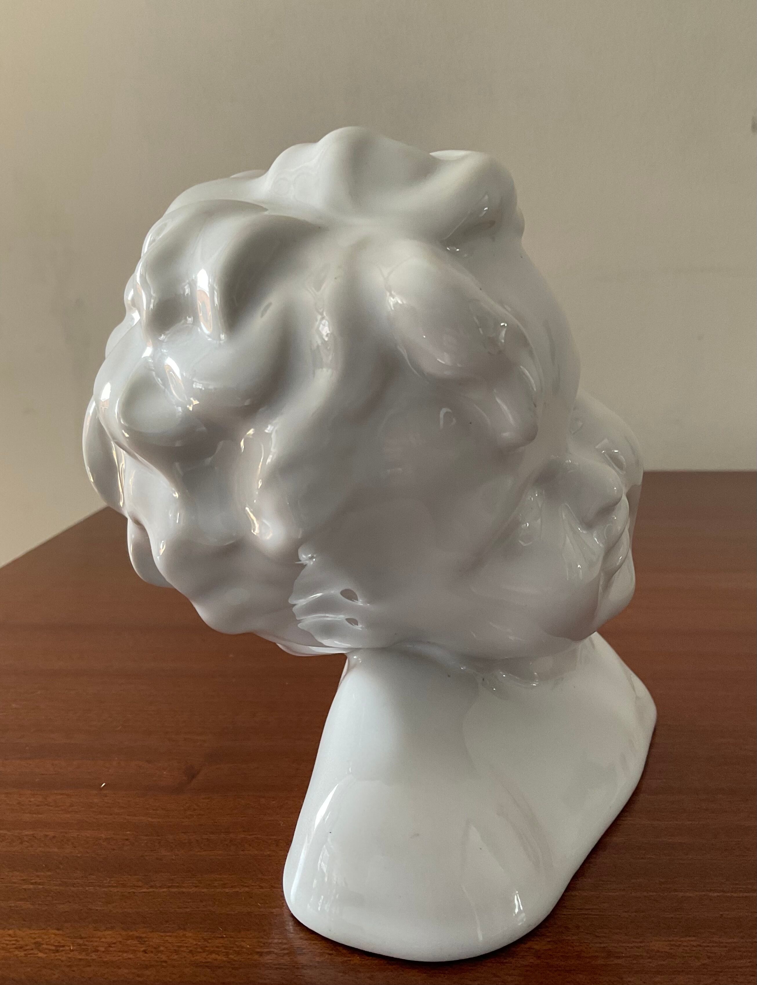 Cherub child bust in enamelled porcelain