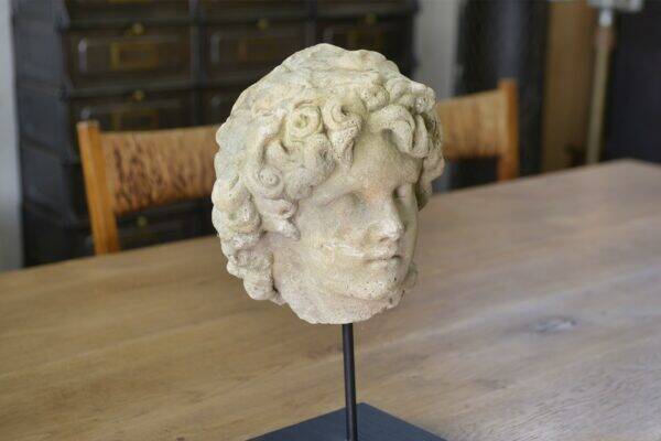 Sculpture of a head in reconstituted stone carved in the antique style of the 19th century
