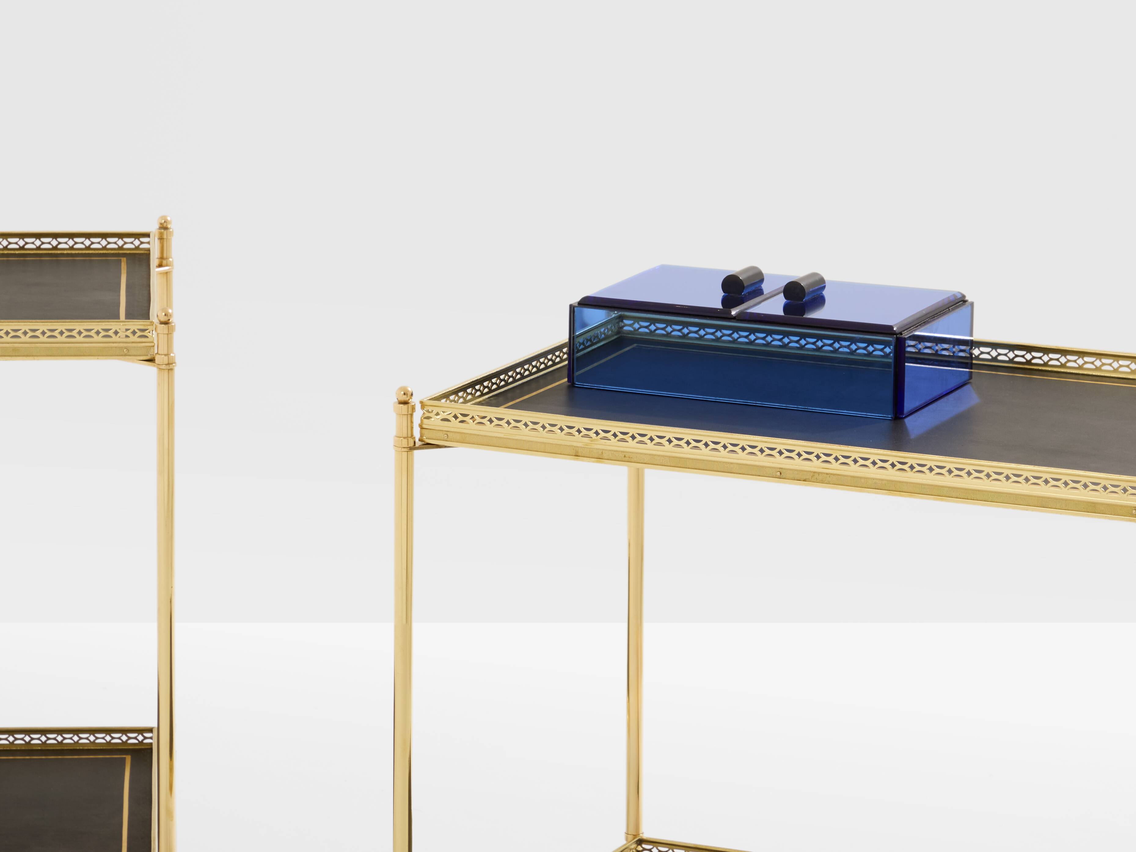 Pair of neoclassical side tables in brass and black leather by Maison Jansen, 1960.