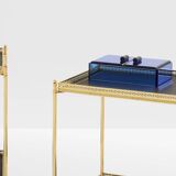 Pair of neoclassical side tables in brass and black leather by Maison Jansen, 1960.