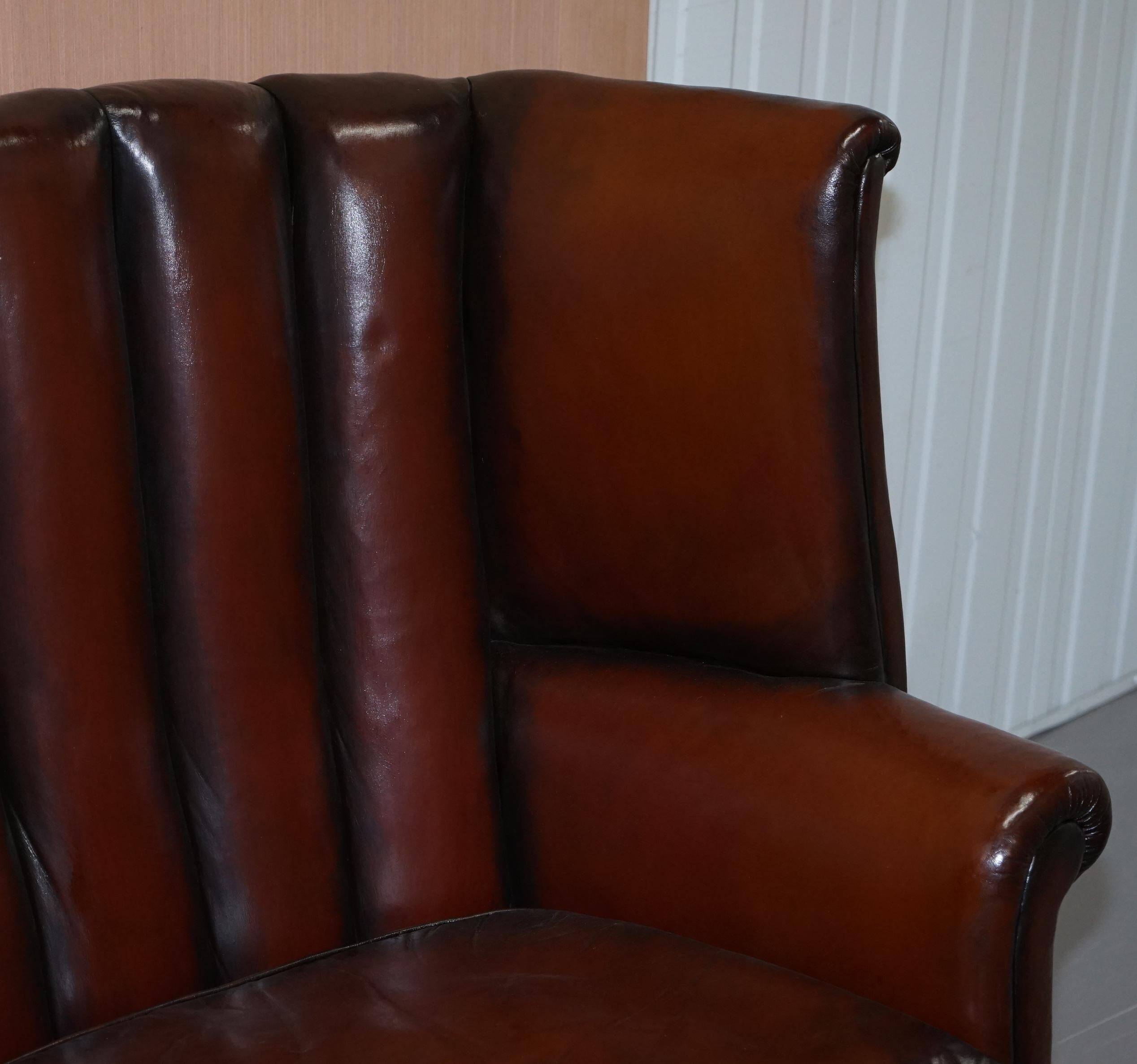 Victorian leather canapé and armchair, barrel back, circa 1860, restored.