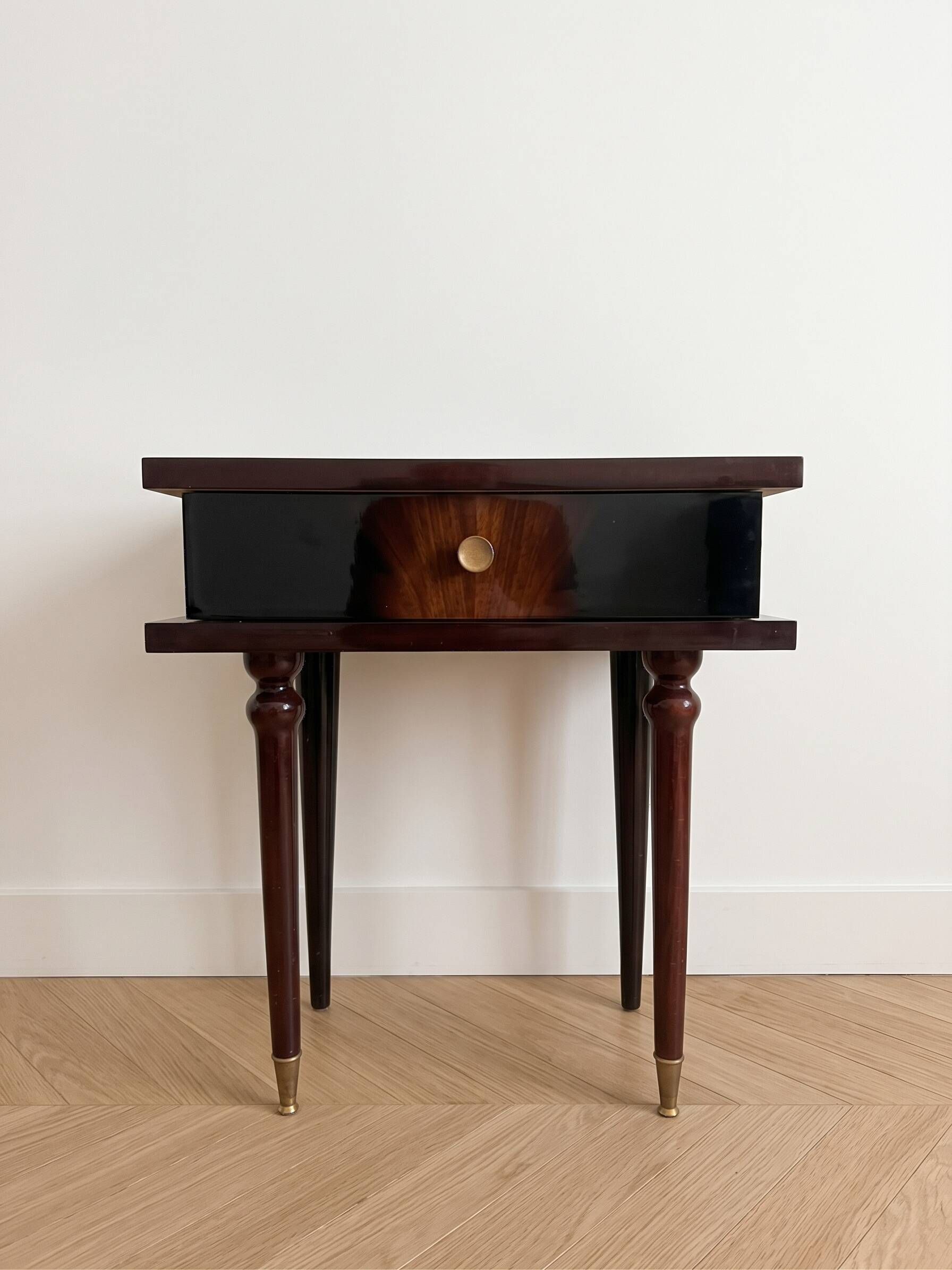 Vintage Art Deco bedside table in dark wood with gold details.