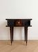 Vintage Art Deco bedside table in dark wood with gold details.