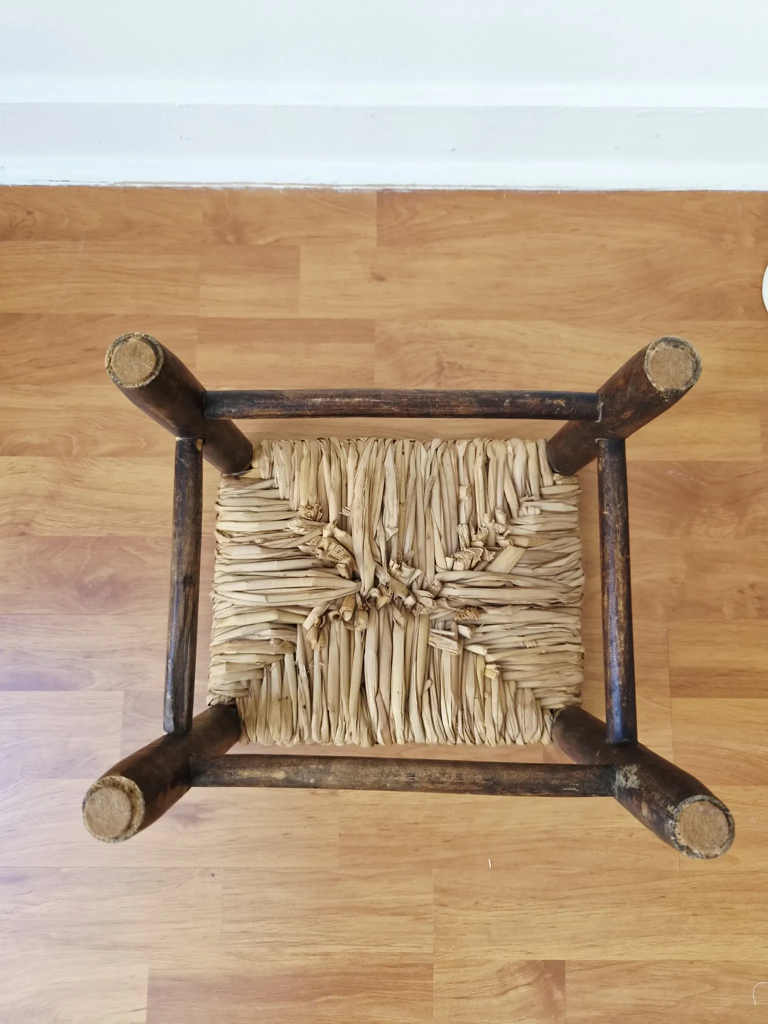 Small rustic vintage wooden and straw stool -
