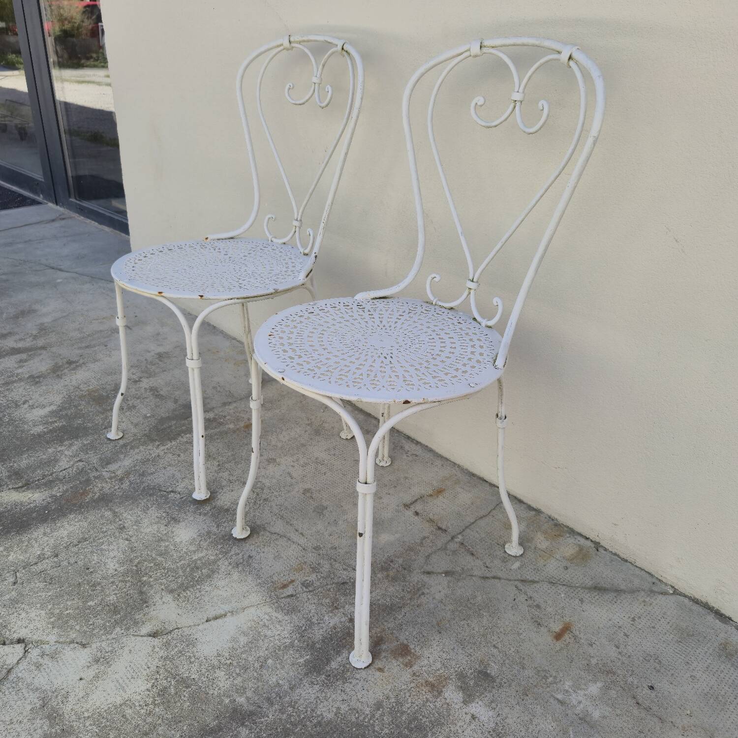 Pair of wrought iron garden chairs, antique manufacture
