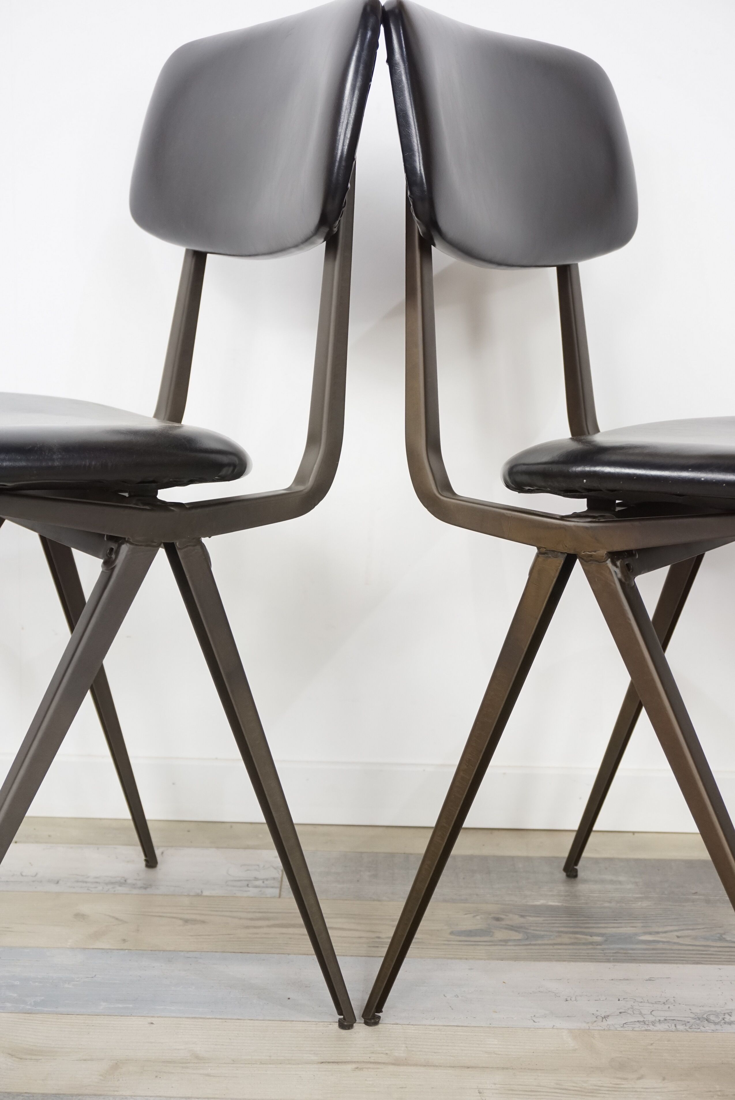 Pair of industrial style chairs in metal and faux black leather