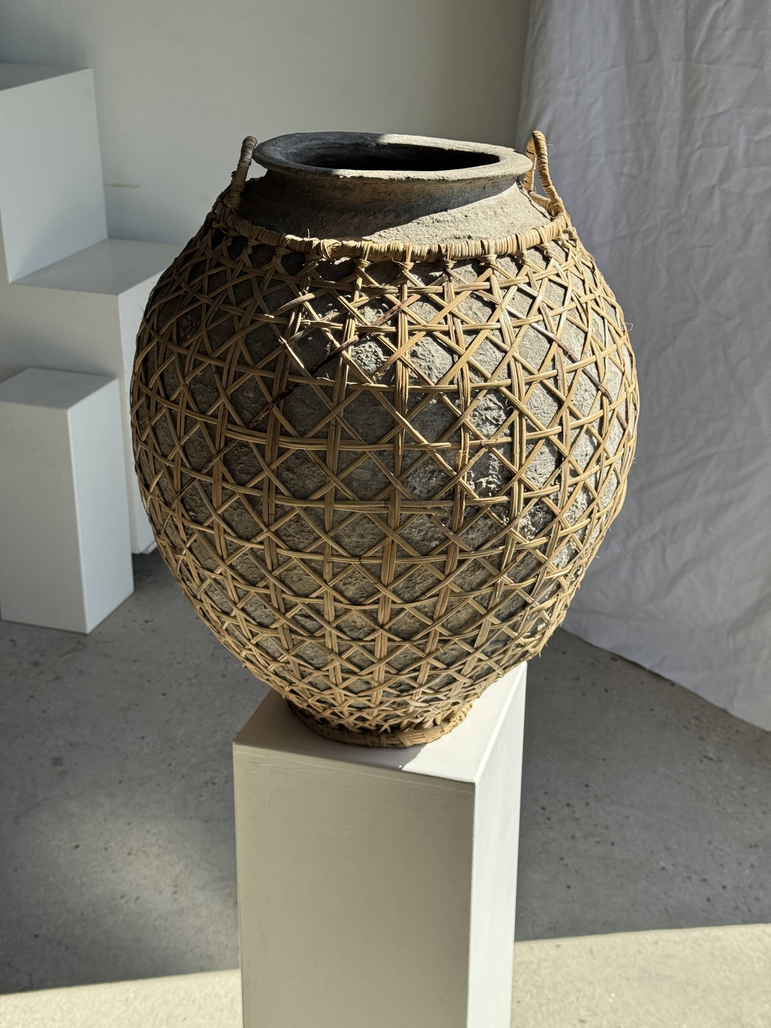 Immense light grey antique-style pot with a crosshatch lid and handles.