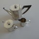 Antique silver Art Deco teapot, sugar bowl, and milk jug.