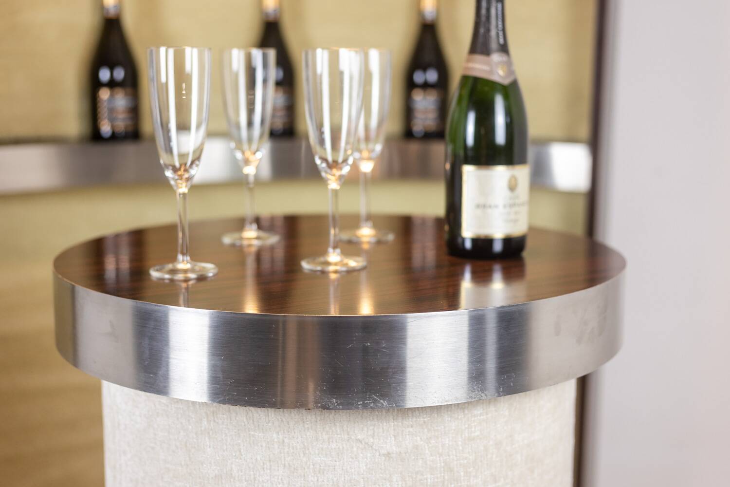 Circular bar in brushed metal, wood and carpet. 1970s.