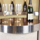 Circular bar in brushed metal, wood and carpet. 1970s.