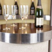 Circular bar in brushed metal, wood and carpet. 1970s.