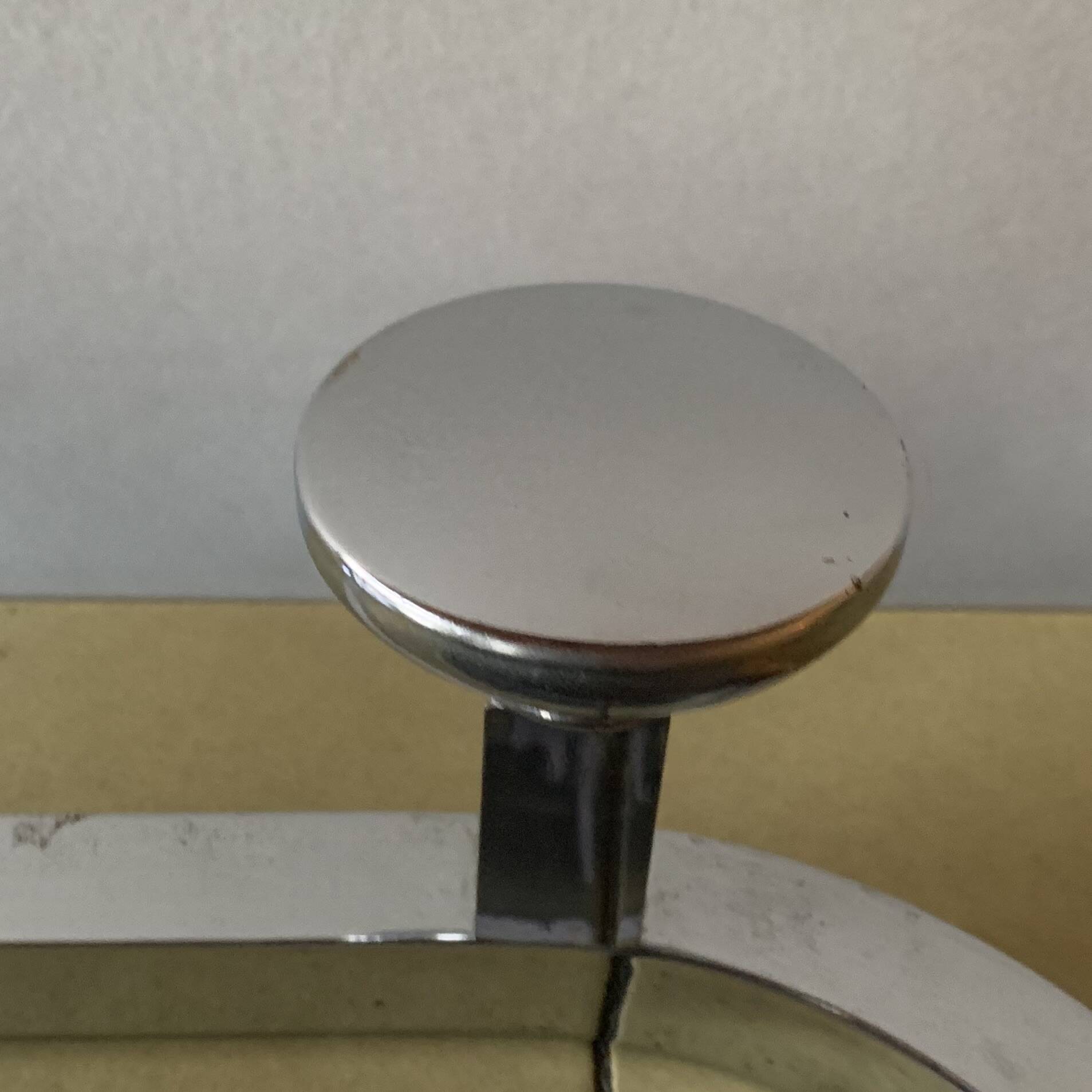 Vintage wall-mounted coat rack in chrome metal with integrated mirror and hat rack