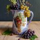 Vintage porcelain pitcher Lusseray France, decorated with grape clusters.