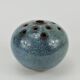 Vase with blue flowers.