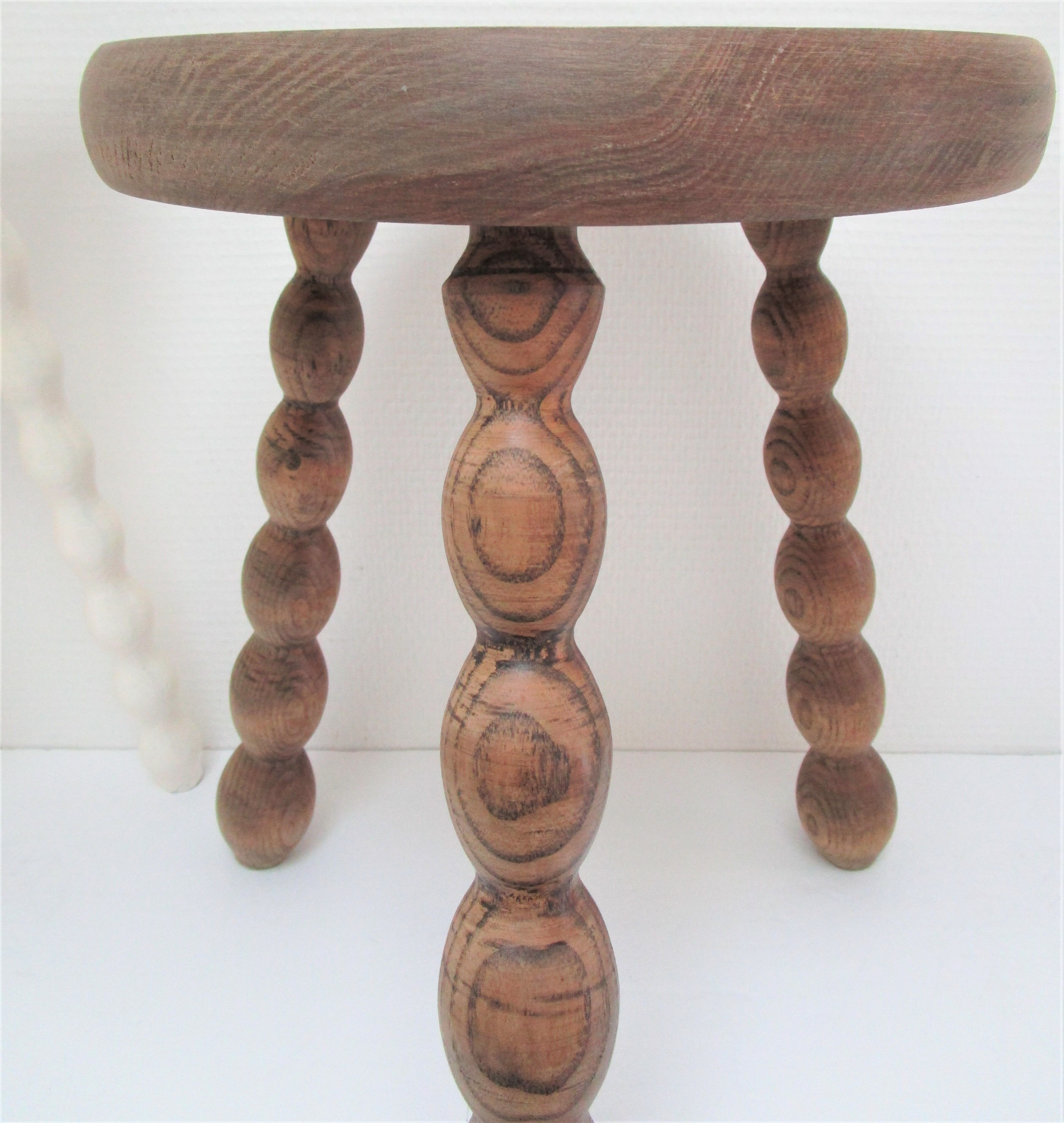 Two vintage tripod solid wood stools