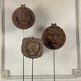 Three cast-iron and terracotta façade decoration lions, around 1880.