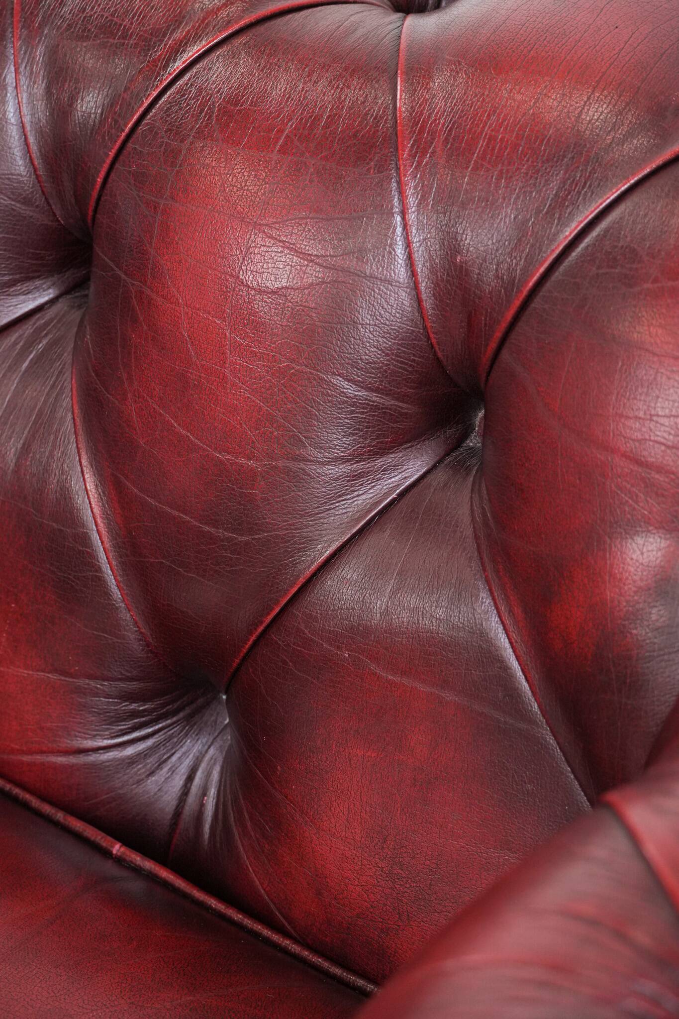 Red English cowhide Chesterfield armchair finished with decorative nails