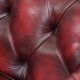 Red English cowhide Chesterfield armchair finished with decorative nails