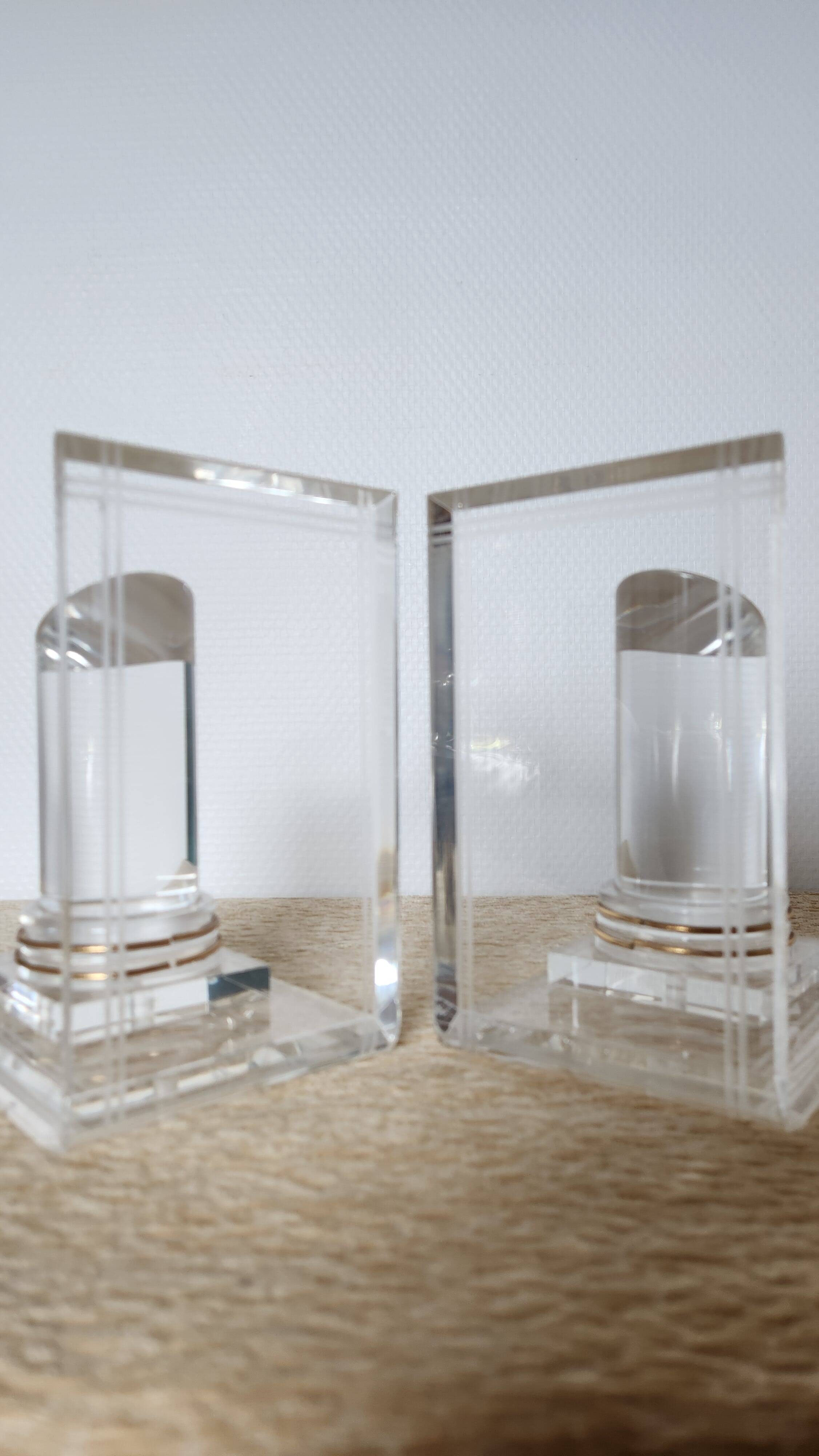Pair of column bookends in plexiglass and gold metal, 1980s design.