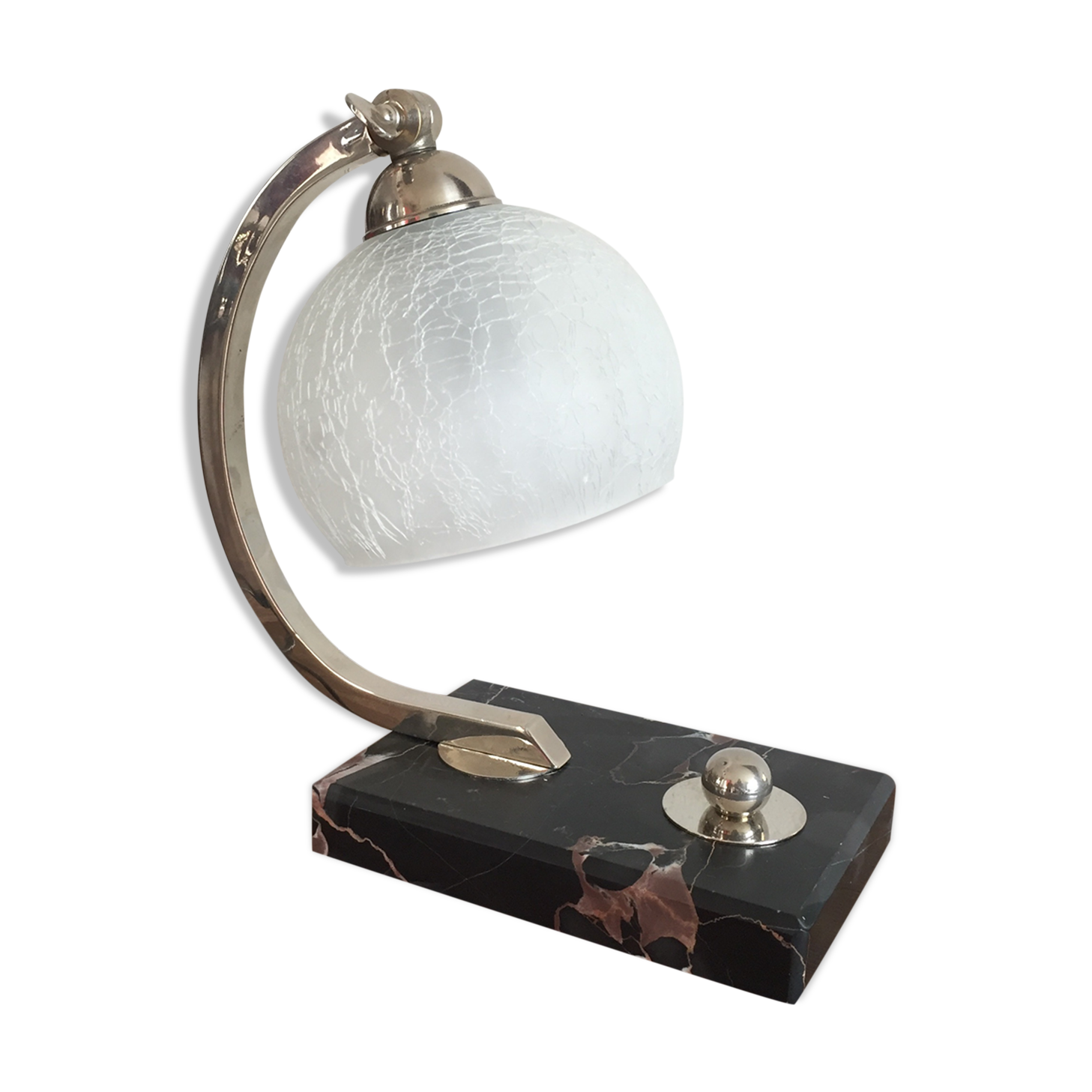 Art-deco lamp on marble with its original metal frame and the globe is cracked glass.