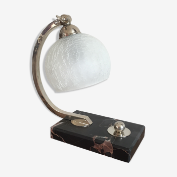 Art-deco lamp on marble with its original metal frame and the globe is cracked glass.