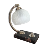 Art-deco lamp on marble with its original metal frame and the globe is cracked glass.