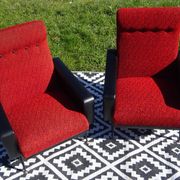 Pair of vintage armchairs in black faux leather and red fabric.