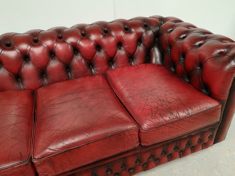Three-seater red leather chesterfield sofa
