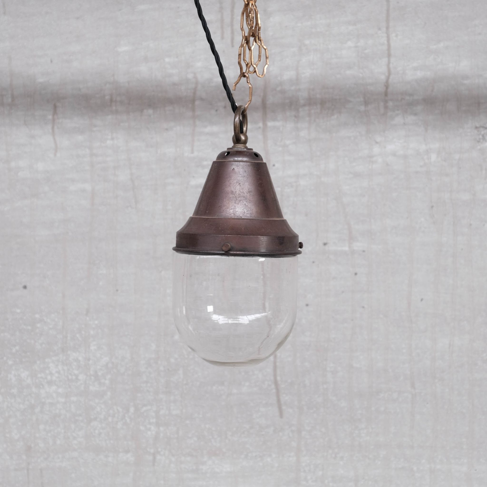 Pair of brass and clear glass industrial pendants