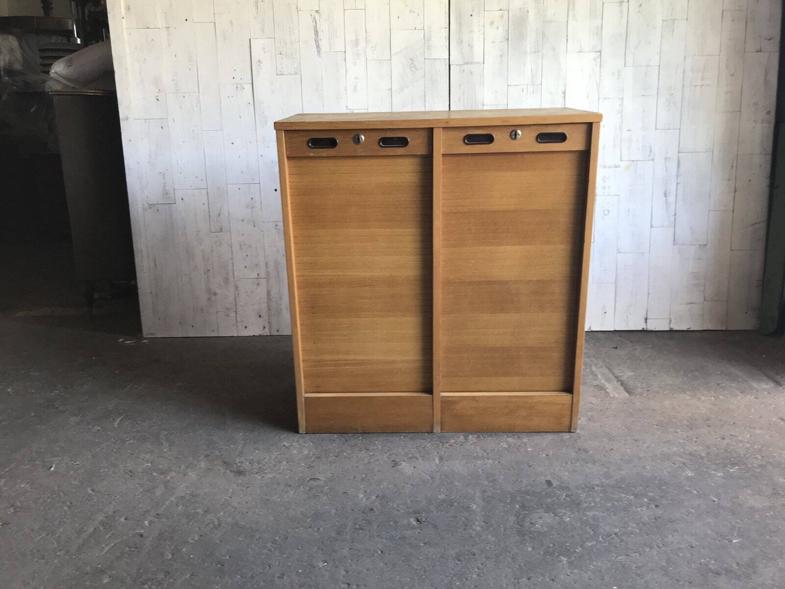 Mid-century industrial haberdashery cabinet in brown oak, double tambour, 1950s.
