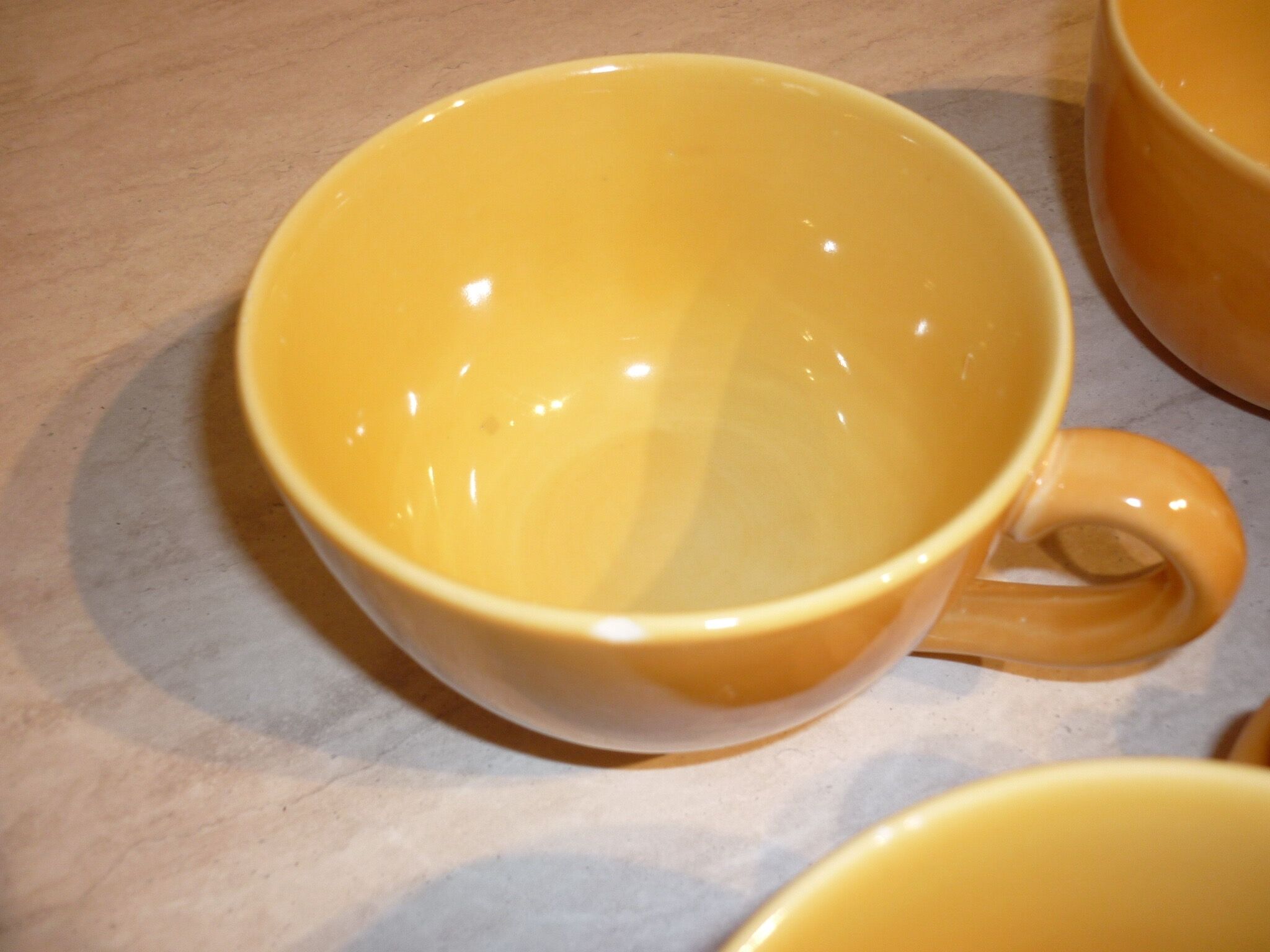 4 yellow and orange ceramic cups