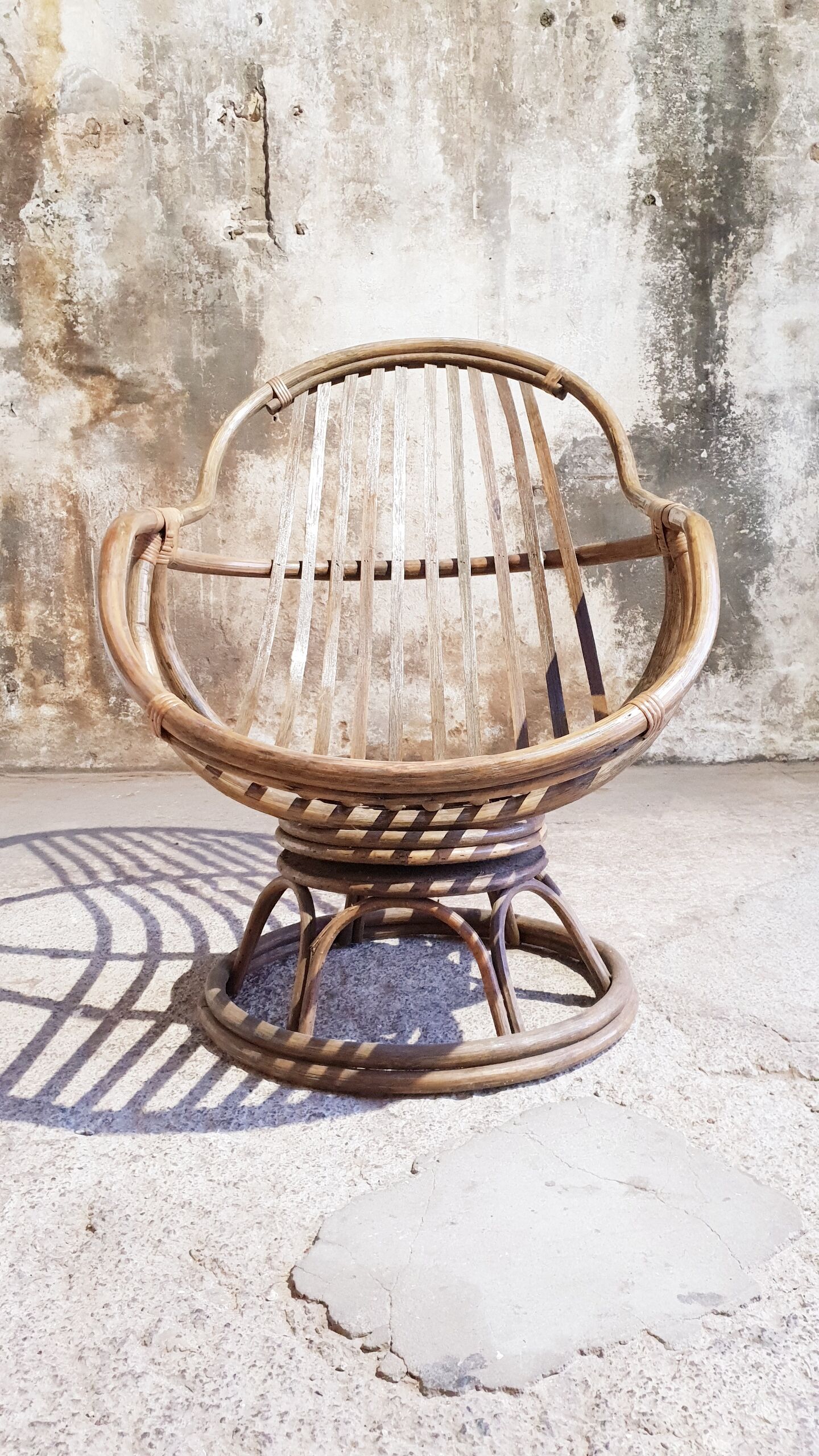 Antique swivel rattan armchair