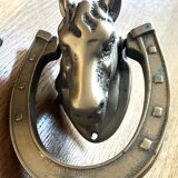 Horse head on horseshoe door knocker