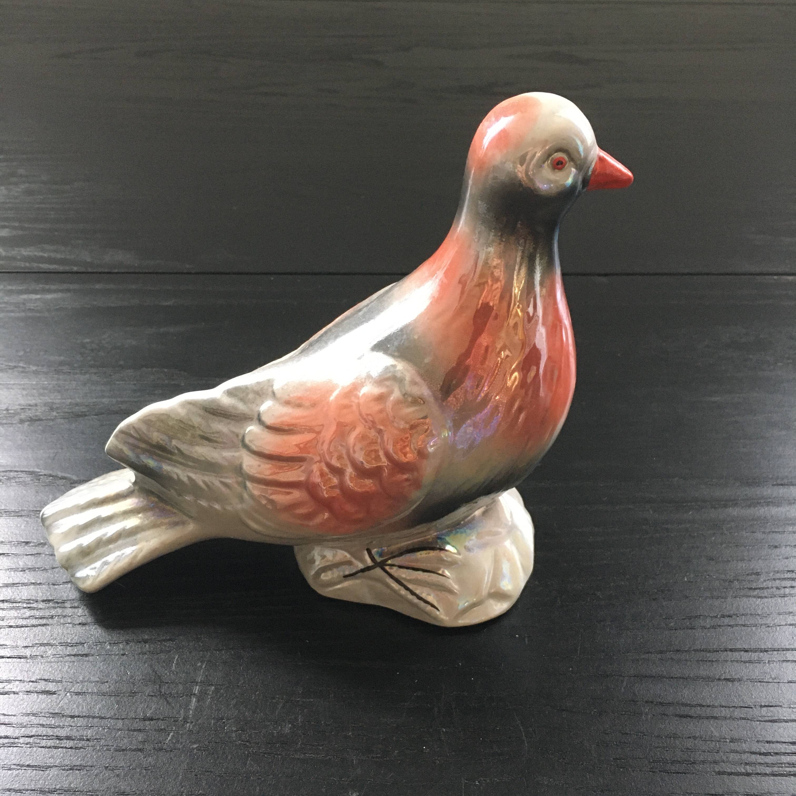 Antique bird in pearly ceramic