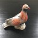 Antique bird in pearly ceramic