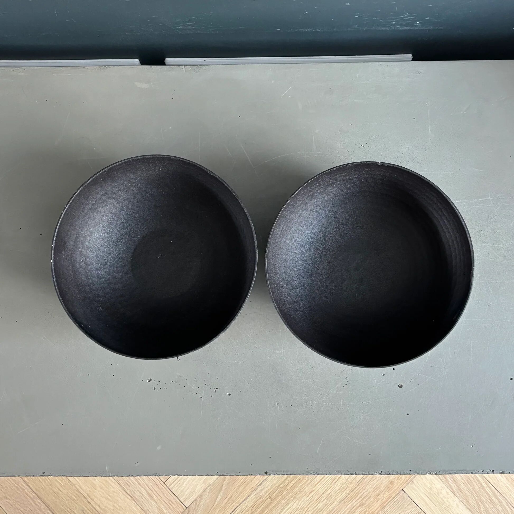 Pair of black lacquered metal catchall bowls