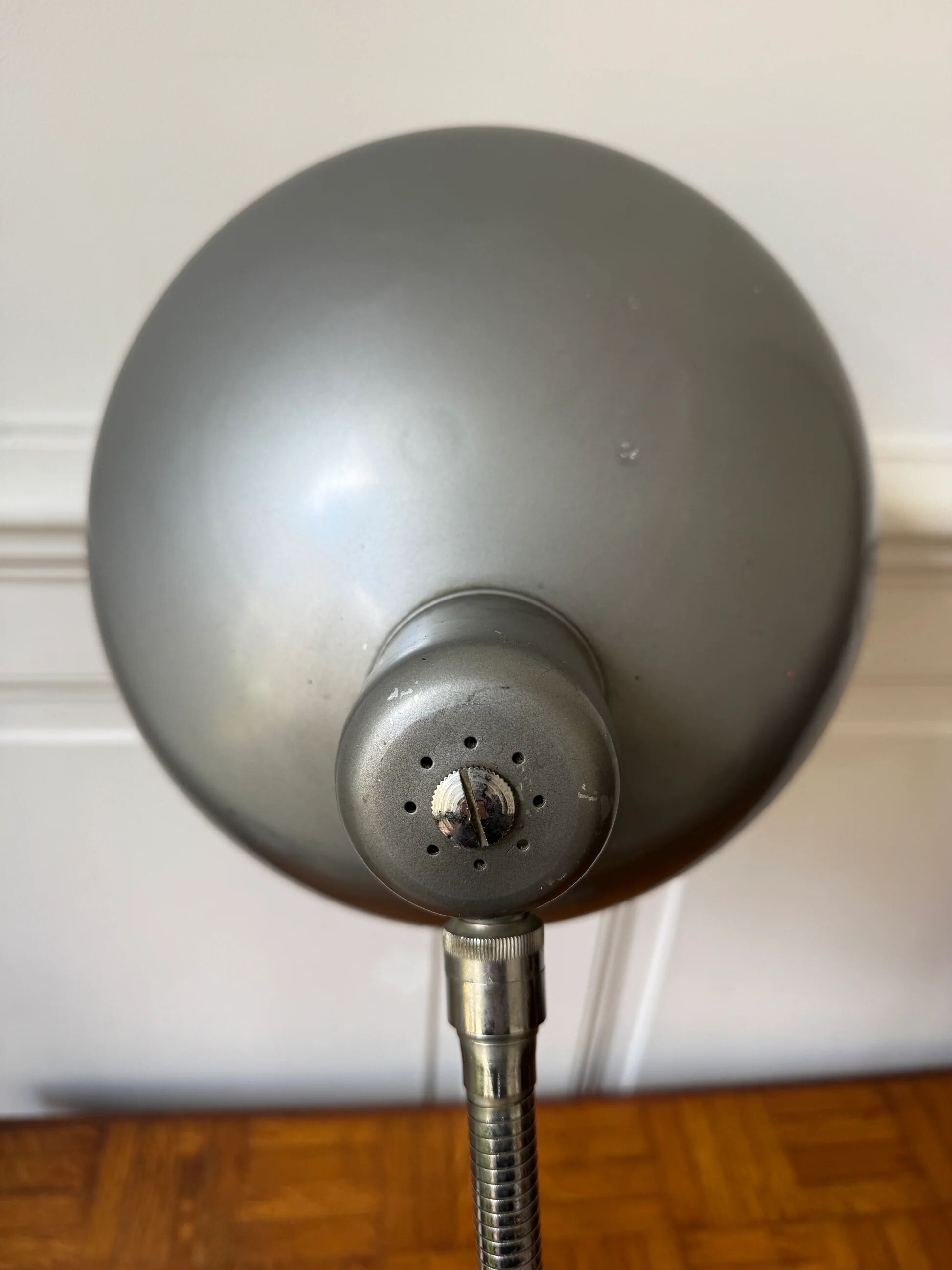Industrial metal workshop lamp with a gooseneck.