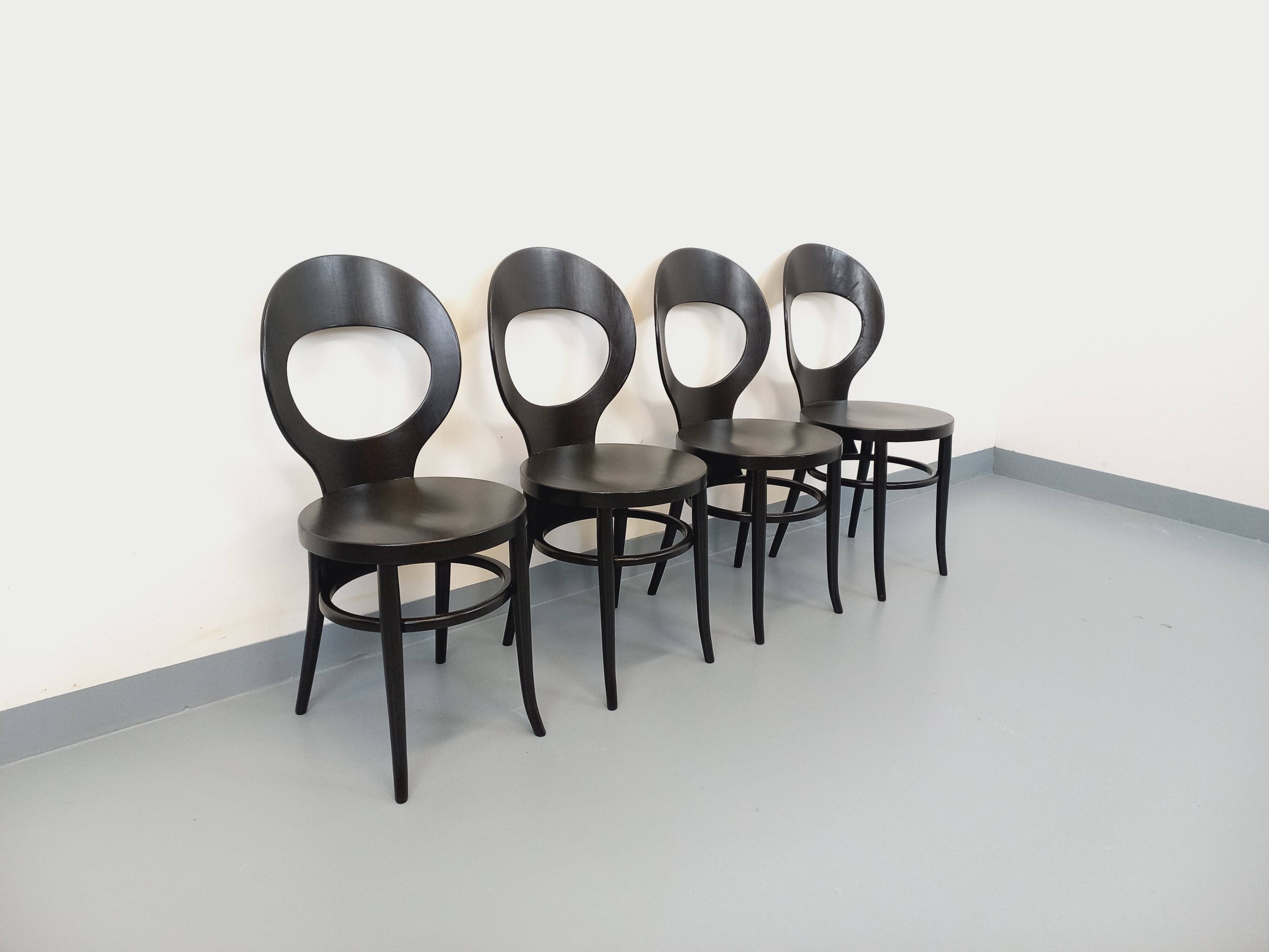 Set of 4 vintage Mouette chairs by Baumann in black wood from the 1960s.