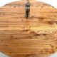 Modernist round table in solid elm, crossed legs.