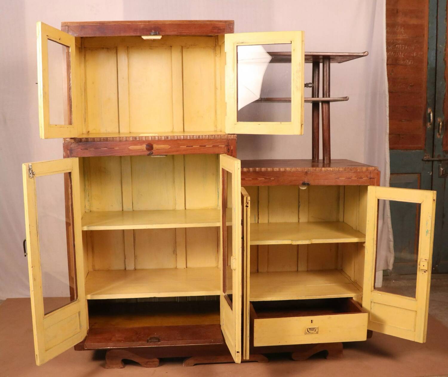 Antique Art Deco display cabinet in Burmese teak with original yellow patina interior.