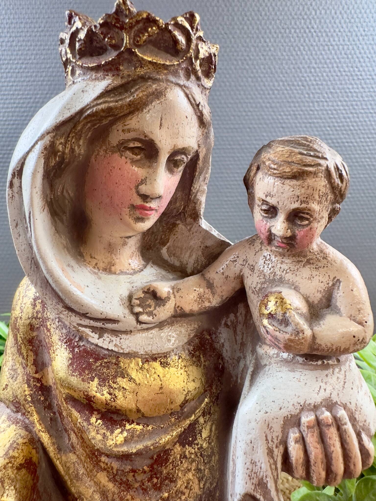 Statue of the Virgin holding the Child Jesus in polychrome terracotta.