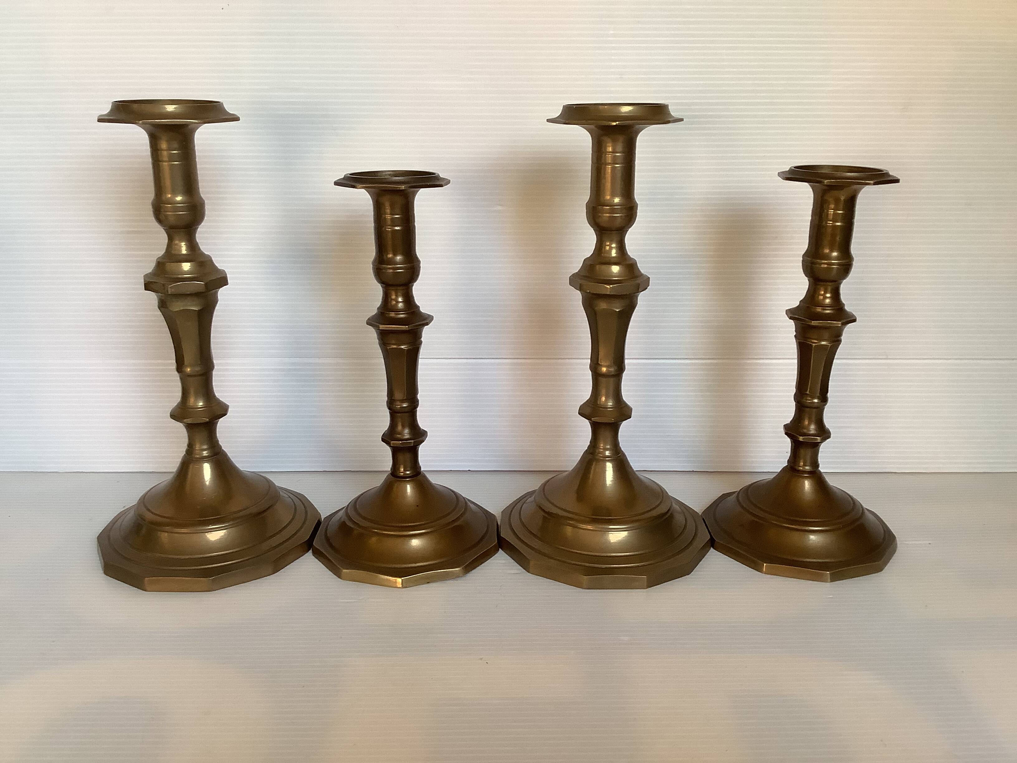 Four brass candle holders