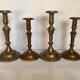 Four brass candle holders